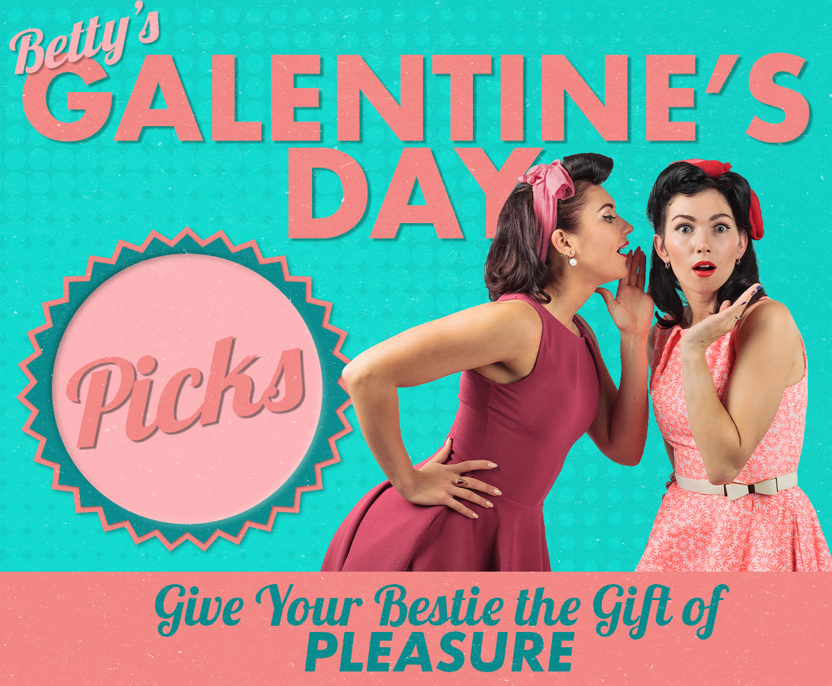 Two women in vintage dresses gossip, one whispering to the other, under text that reads "Betty's Galentine's Day Picks. Give Your Bestie the Gift of Pleasure." Retro, colorful design.