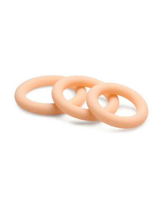 Three interlocking silicone cock rings of graduated sizes on a white background - Curve Toys Jock Discreet Silicone Cock Ring Set in Vanilla.