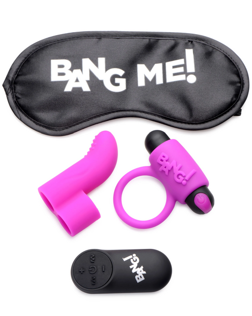 A purple blindfold with the text "BANG ME!" in white, alongside pink silicone adult toys and a black remote control. The toys include a textured finger sleeve, a vibrating ring, and a remote-controlled bullet vibrator. The remote control has buttons and branding that reads "BANG!" in white. Product: BANG! Couple's Cock Ring, Finger Vibe, Bullet & Blindfold Kit - Purple by XR Brands.