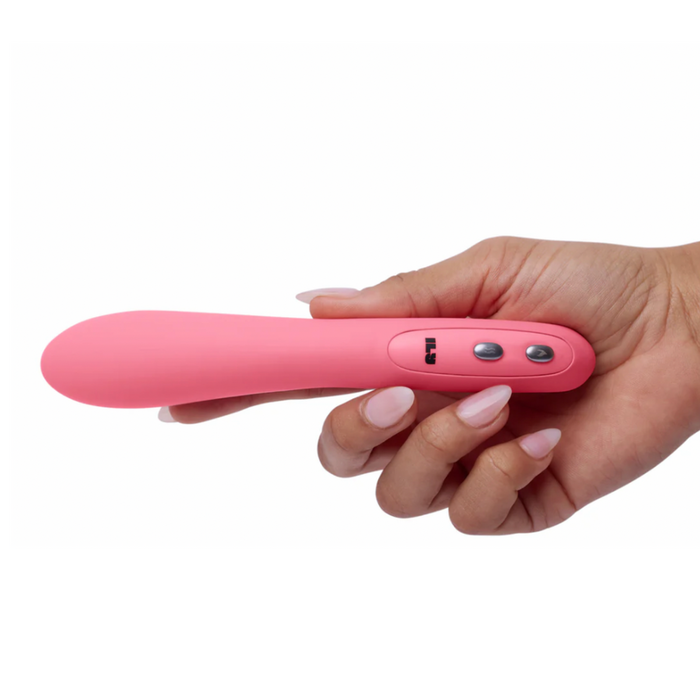 A hand holds the Ily Flexible Warming G-Spot Vibrator, a pink, curved wand made from body-safe silicone with control buttons, set against a white background.
