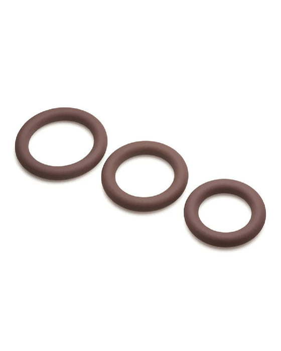 Three Curve Toys Jock Discreet Silicone Cock Ring Set - Chocolate arranged in graduated sizes on a light background.