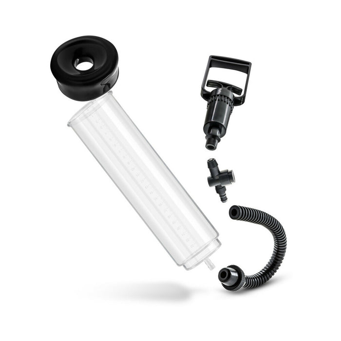 The Performance VX3 Male Enhancement Pump System with Cock Ring features a transparent chamber, black rubber base, hand pump, flexible hose, and connector—designed to support firmer erections. Shown disassembled on a white background.