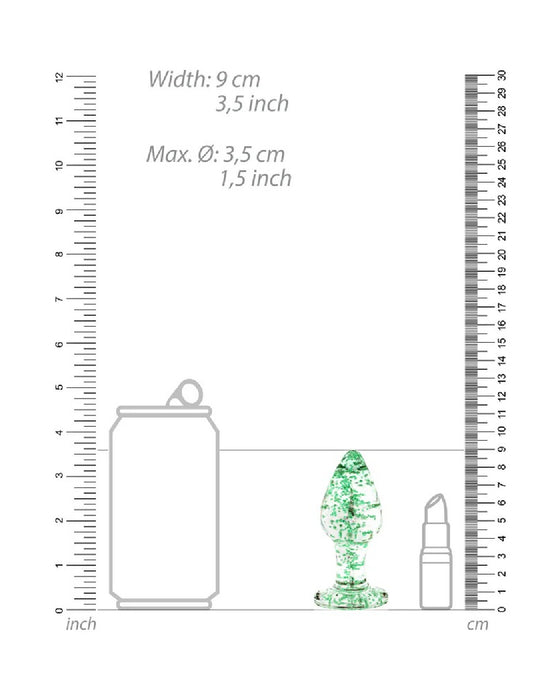 Illustration comparing the size of a beverage can, a lipstick tube, and a Shots Glow in the Dark Glass Anal Plug - Large against rulers in centimeters and inches.