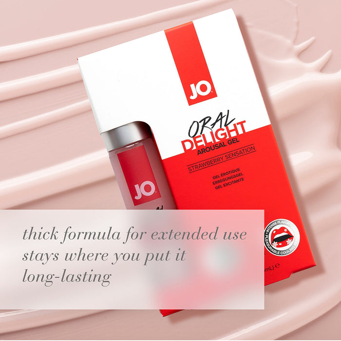 A red and white box and bottle of JO Oral Delight Strawberry Arousal Gel 1 oz are shown on a pink creamy background. Text: "Thick formula for extended use; strawberry arousal gel for long-lasting oral pleasure.