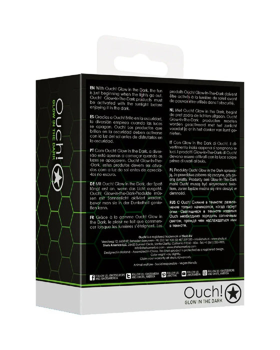 Packaging for "Shots Glow in the Dark Glass Anal Plug - Large" featuring a black and green design with a soccer ball motif and a star emblem, along with multiple text descriptions.