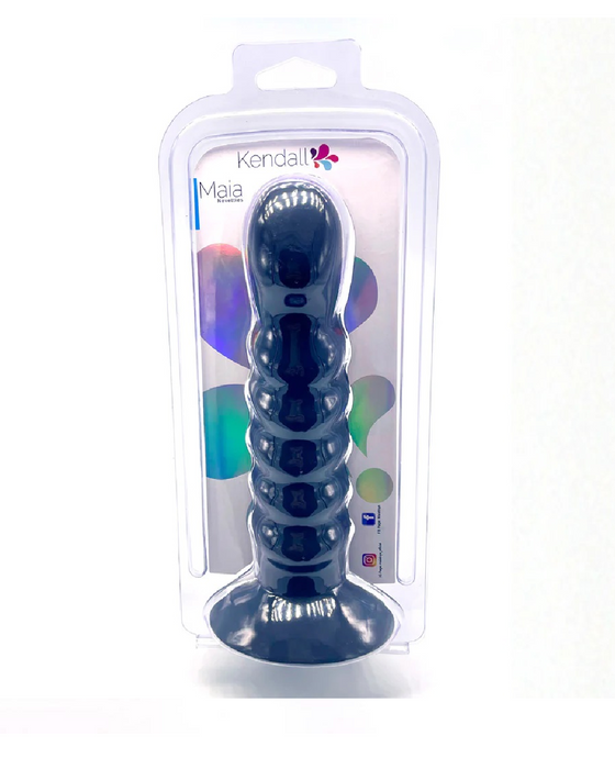 A product image displaying a Maia Toys branded "Kendall" silicone ribbed dildo in its packaging, featuring a black color and ribbed texture designed for pleasure.