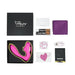 Unboxed Tracy's Dog OG Clitoral Sucking G-Spot Vibrator set with pink toy, black and pink box, USB cable, manual, purple pouch, and assorted stickers and cards laid out neatly on a white background.