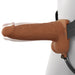 The Fantasy X-Tensions Elite Vibrating Hollow 6 Inch Silicone Dildo & Strap-On Harness in Chocolate features a realistic brown dildo with testicles, attached to a black harness worn around the waist.