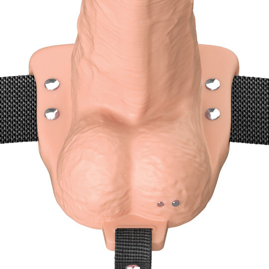 The Fantasy X-Tensions Elite Vibrating Hollow 6 Inch Silicone Dildo & Strap-On Harness - Vanilla features a realistic, flesh-toned dildo with black adjustable straps and metallic studs at the base for secure attachment.