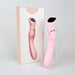 The Chance Waterproof Touch Screen G-Spot Vibrator, made from medical-grade silicone, is pink with a gold accent and stands upright on a clear stand beside its matching box featuring the product image against a light background.