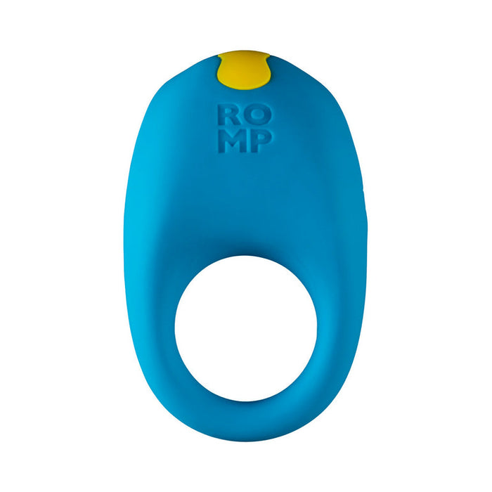 The Romp Juke Silicone Vibrating Couples Cock Ring is blue with a yellow top button and "ROMP" embossed on it. Designed for adults, it's waterproof, has a large circular opening, and delivers versatile pleasure.