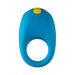 The Romp Juke Silicone Vibrating Couples Cock Ring is blue with a yellow top button and "ROMP" embossed on it. Designed for adults, it's waterproof, has a large circular opening, and delivers versatile pleasure.