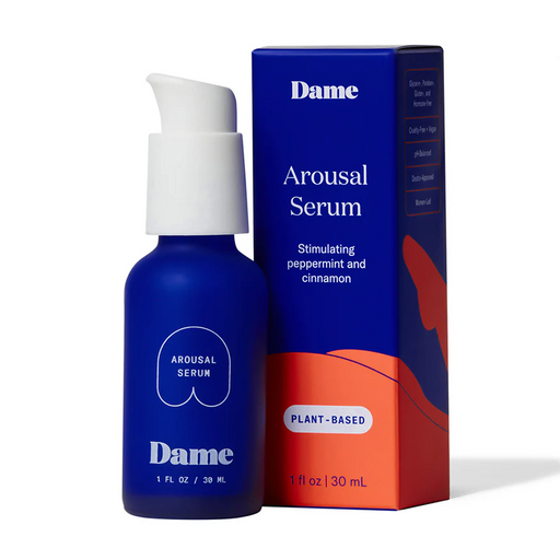 A blue bottle of Dame Lickable Clitoral Arousal Serum 1 oz stands beside its matching blue and orange box, highlighting a plant-based formula with peppermint and cinnamon for clitoral stimulation.