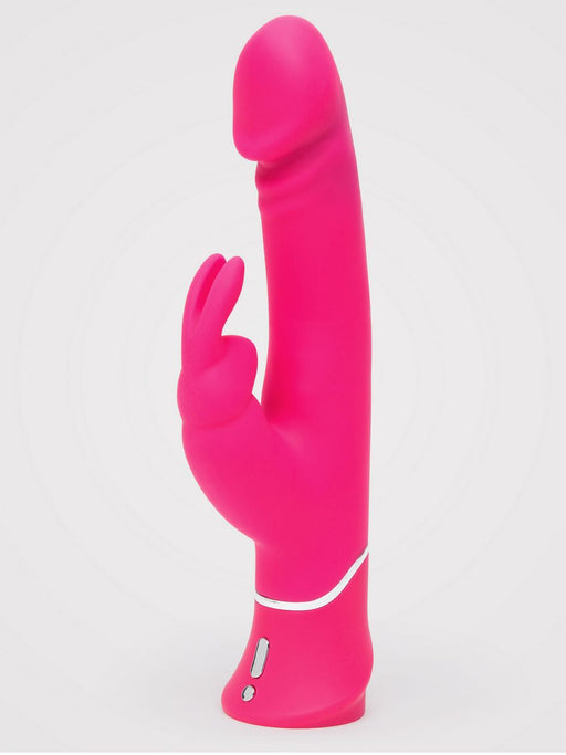 The Happy Rabbit Dual Density Rechargeable Silicone Rabbit Vibrator, featuring a bright pink phallic shape, curved shaft, and bunny ear external stimulator, stands upright against a plain white background.