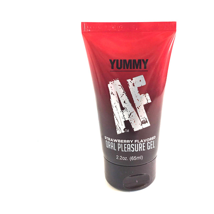A red and black tube of Yummy AF Oral Pleasure Gel (Strawberry, 2.2 oz) stands upright on a white background—delicious and water-based, perfect for oral fun.
