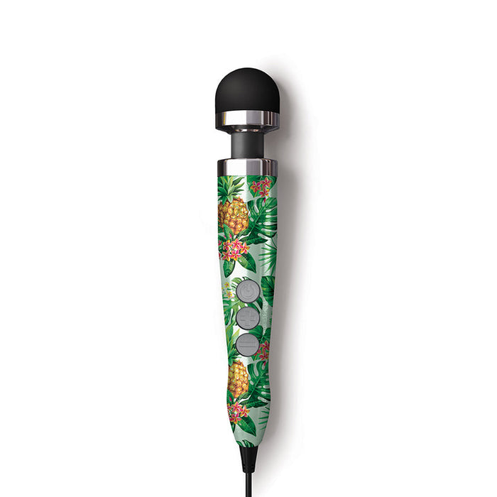 The Doxy Die Cast 3 Compact Wand Vibrator Pineapple Pattern features a black rounded head and a handle with tropical pineapples and green leaves, delivering deep rumbles and shown against a white background.