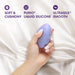A hand with white-painted nails holds the Serene Silicone Waterproof Palm Vibrator, a small purple oval massager, against silky fabric. Text above reads: "Soft & Cushiony," "Purio Liquid Silicone," and "Ultrasilk Smooth.