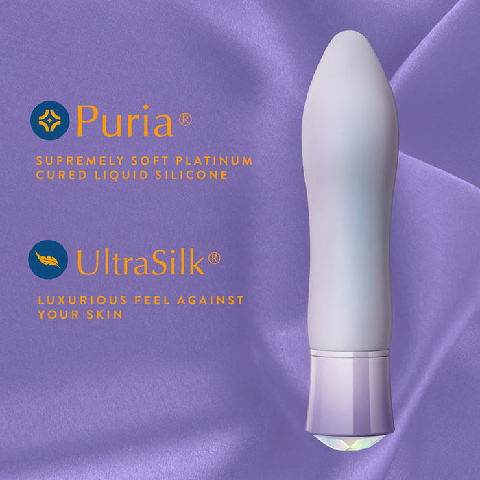 A lavender Opal Heating Waterproof Silicone Vibrator stands vertically on a silky lavender background. Text: "Opal—Supremely soft platinum-cured silicone" and "UltraSilk—Luxurious feel against your skin.