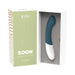 A Zini Soon Silicone G-Spot Vibrator in teal and white, made of ultra-soft silicone, is shown in an open box next to its green packaging featuring a line drawing of the product and product details.