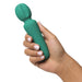 A manicured hand holds the Petite Private Pleasure Waterproof Silicone Wand Vibrator—a green silicone massager with a ribbed, rounded head.
