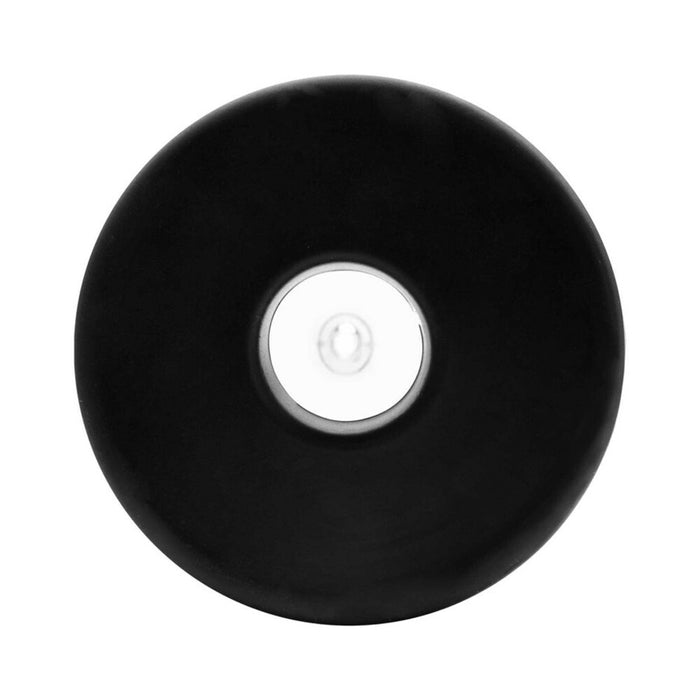 A black, smooth-surfaced circular part with a clear center, seen from above on a white background, is a component of the Performance Starter Penis Pump for Firmer Erections.