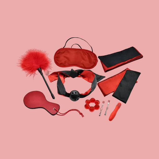 The Sensual Scarlet Nights Beginner Bondage Collection for Curious Couples includes a blindfold, feather tickler, gag, paddle, wrist restraints, nipple clamps, a small vibrator, and a ring in striking red and black.