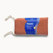 A rust-colored, ultra-soft cotton blanket with white drawstring ties, wrapped in a blue label reading "Dame Thro Soft Waterproof Sex Blanket"—perfect for play, fully waterproof, and machine washable for easy cleaning.