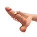A hand holding the b-Vibe Slipskin Realistic 9 Inch Girthy Silicone Dildo in Caramel, designed for lifelike sensations and compatible with strap-on harnesses.