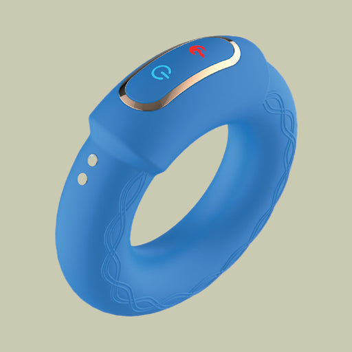 The Royale Warming Vibrating Cock Ring for Couples is a blue silicone ring-shaped device with heating and vibration, control buttons with power and sound icons on top, and decorative side patterns, shown against a plain light background.