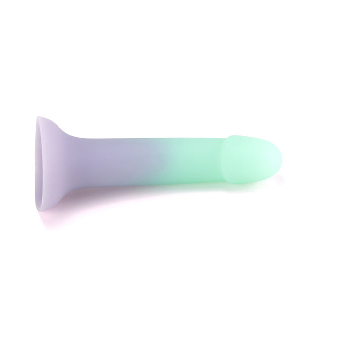 The Ombre Curve Liquid Silicone 6 Inch Slim Dildo features a pastel ombré design, fading from light purple to mint green, with a flared suction cup base for G-Spot stimulation, shown on a white background.
