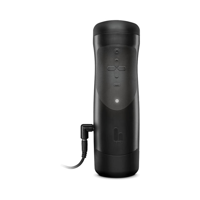 The Handy Adjustable Hand Job Penis Stroker is a black, cylindrical electronic male masturbator with front control buttons and a charging cable attached, shown against a white background.