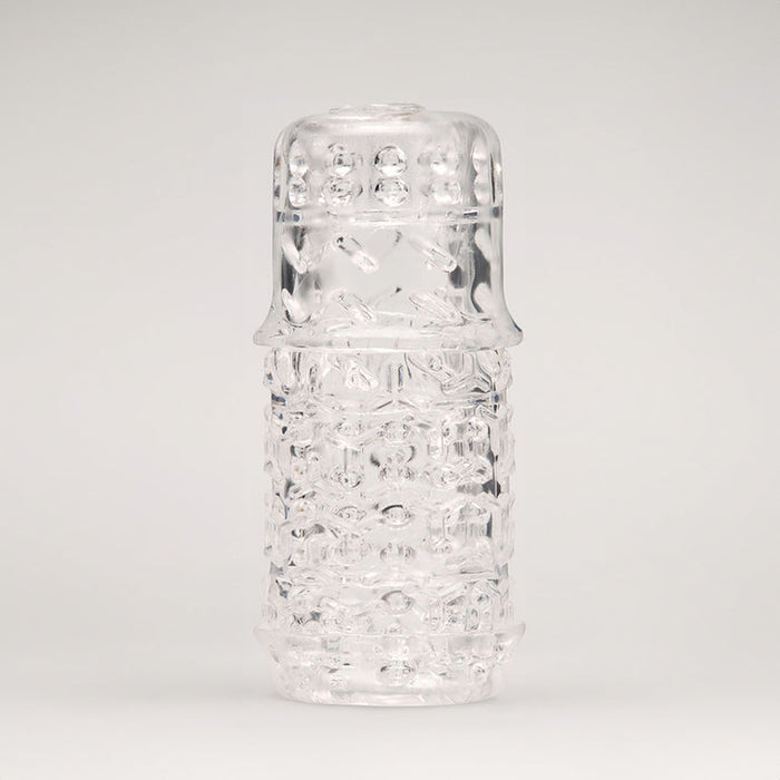 The Handy TrueGrip Gen 2 Sleeve features a longer, thicker textured design and stands upright against a plain, light background, highlighting its cylindrical shape and enhanced grip pattern on the rounded cap.