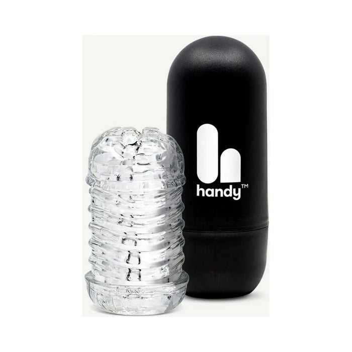 The Handy Dream Collection Touch Sleeve, a transparent textured cylinder for targeted stimulation, is displayed beside a black capsule-shaped case marked "handy" with a white logo.