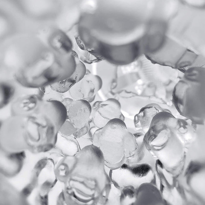 Close-up of transparent gel beads clustered together with soft light, creating a shiny, abstract texture—evoking the smooth sensations and appeal of The Handy Dream Collection Chrysm Sleeve.