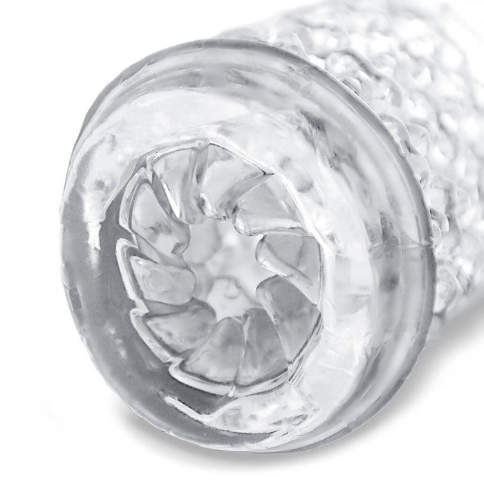 Close-up of The Handy Dream Collection Chrysm Sleeve—a transparent, textured cylindrical stroker with a circular opening and petal-like inner ridges, designed to enhance anal penetration sensations.