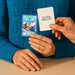 Two hands hold up cards from the Together Couples Intimacy Card Game—one shows vibrant cartoon art and "HEART TO HEART"; the other asks, "How would you describe your love language, and has it changed over time?" Great for couples' communication.