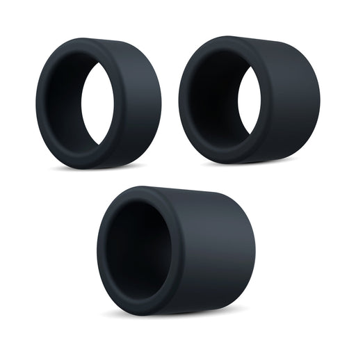The Accelerate Thick Stretchy Black Silicone Cock Rings - Set of 3 are shown on a white background in a loose triangle. Each black, cylindrical ring boasts a smooth, matte finish and hollow center for versatile use.