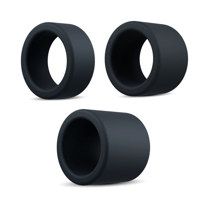 The Accelerate Thick Stretchy Black Silicone Cock Rings - Set of 3 are shown on a white background in a loose triangle. Each black, cylindrical ring boasts a smooth, matte finish and hollow center for versatile use.