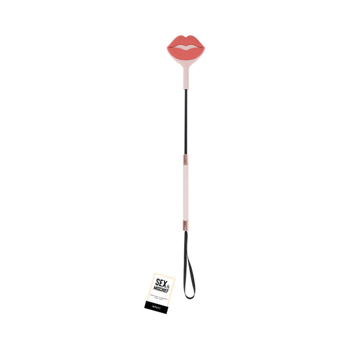 The Peaches 'n Cream Silicone Kiss Crop is a playful pink crop with a handle, black strap, and red lips-shaped silicone paddle—perfect for adventurous play and leaving a cheeky kiss impression.