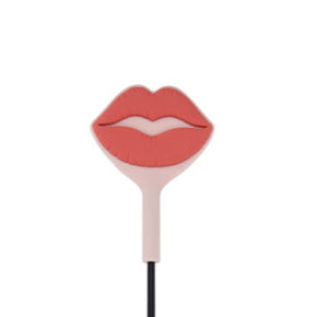 Add a playful touch with the Peaches 'n Cream Silicone Kiss Crop—a spanking toy shaped like pink and red lips, perfect as a fun decorative accessory on any plain white background.