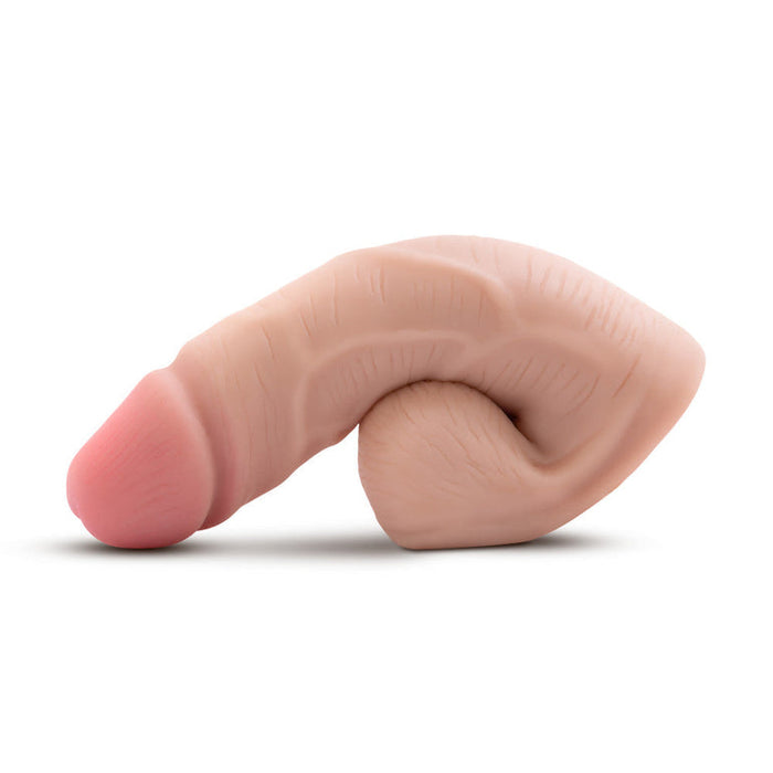 The URSELF 5 Inch Vanilla Silicone Packer Dildo is a realistic, flesh-colored model made from body-safe platinum-cured silicone, shown bent and curled on a white background.