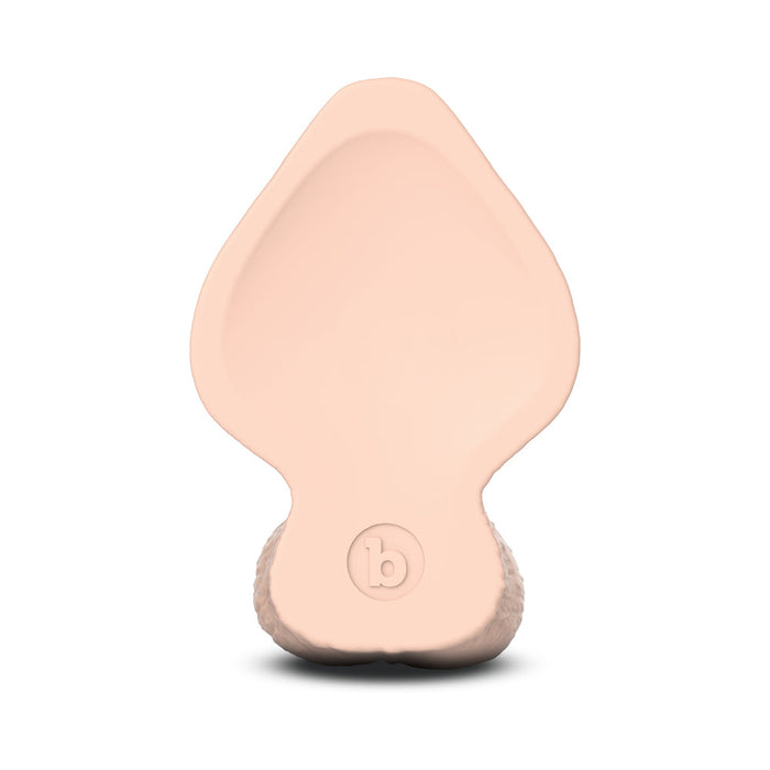 The b-Vibe Slipskin Realistic 6 Inch Girthy Silicone Dildo in Vanilla is a light pink, leaf-shaped silicone toy with a rounded base and "b" logo. Its smooth top and textured bottom edge combine style and comfort.