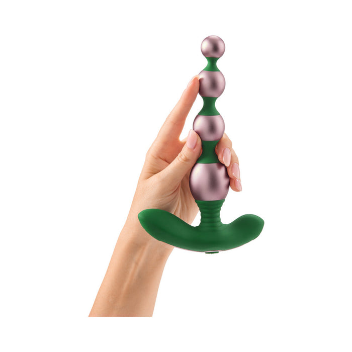 A hand holds the Bougie Vibrating Aluminum Anal Beads, a green and metallic pink beaded anal toy with a flared base, against a white background.