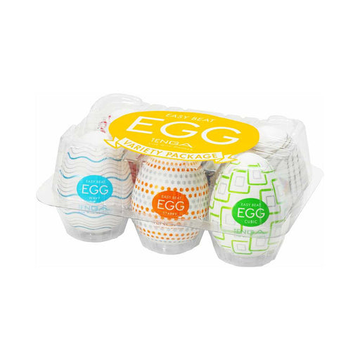 A clear plastic carton holds six Tenga Egg Variety Pack Disposable Masturbators, each with colorful patterns. The packaging and egg-shaped designs resemble Easter eggs, but each is a stretchable male pleasure sleeve.