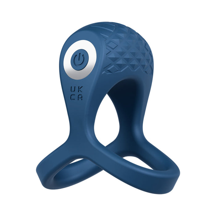 The Dual Flex Pro Vibrating Silicone Couples' Ring with Ball Strap is a dark blue silicone ring with textured dome, power button, and two flexible loops, shown on a white background.