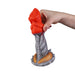 A hand holds the Splash Garon Squirting 7.5 Inch Dragon Creature Dildo, featuring a sculpted red top and textured gray base with gold accents in a mythical dragon-inspired design, shown against a white background.