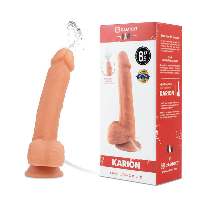 The Karion Realistic Squirting Dildo by Camtoyz is flesh-toned, lifelike, harness-compatible, and features a suction base and hose. It's shown next to its box displaying product images and details.