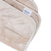 A beige Splash Blanket The OG Waterproof Blanket - Medium, featuring a white label and subtle heart design, is folded to display its plush top and fuzzy waterproof underside.