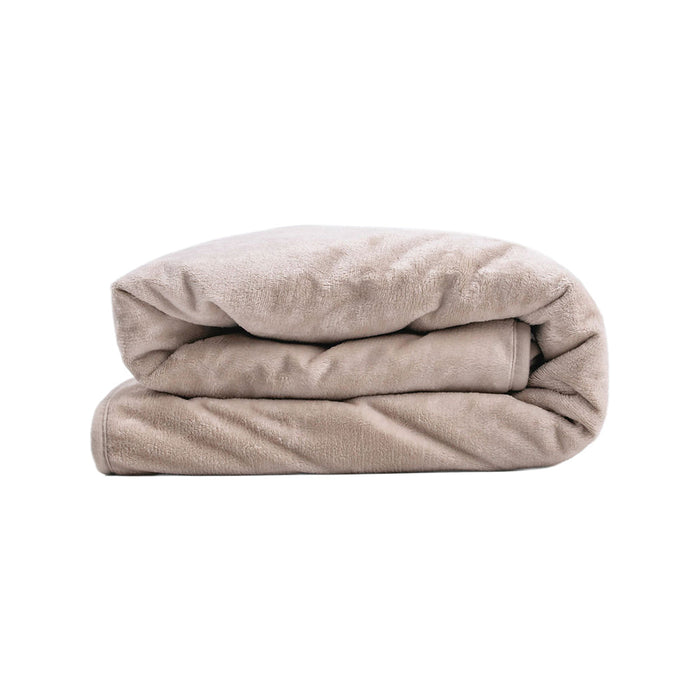 The Splash Blanket The OG Waterproof Blanket - Medium in light beige, neatly folded to showcase its soft, velvety texture, is displayed against a plain white background.