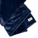 A close-up of the Splash Blanket Furlush Luxurious Faux Fur Waterproof Blanket in dark blue, showcasing its plush, soft texture and a sewn "Splash" label on one corner.